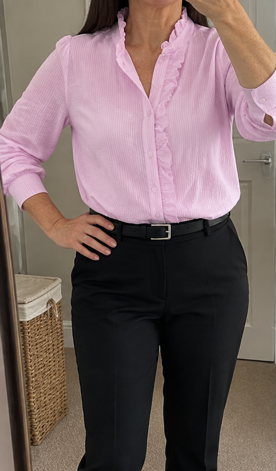 Pink ruffle blouse worn at home, mirror photo